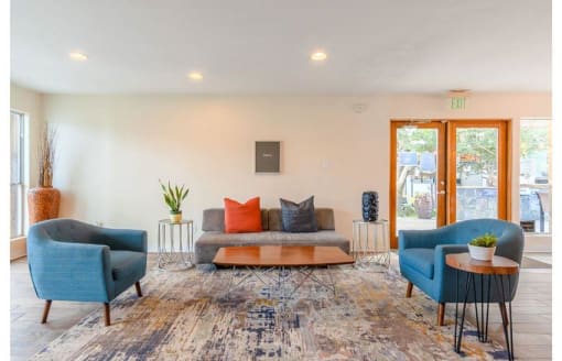 a living room with two blue chairs and a couch at Cityscape, Dallas, TX