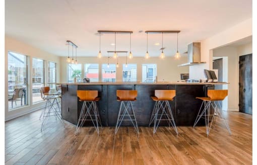 a kitchen with a counter and bar stools at Cityscape, Dallas, TX