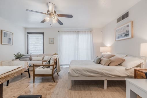 a bedroom with two beds and a ceiling fan at Cityscape, Dallas, TX