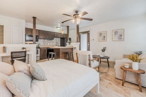 a bedroom with a bed and a living room and a kitchen at Cityscape, Dallas, TX