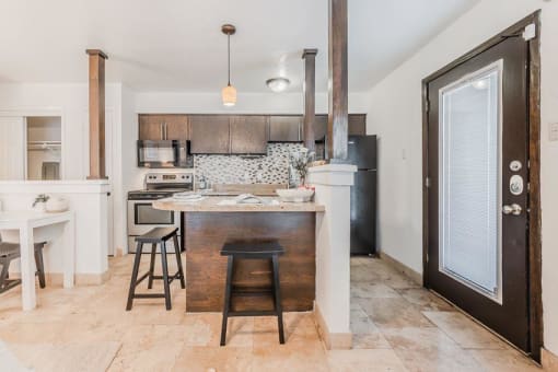 a kitchen with an island in the middle of it at Cityscape, Dallas, TX