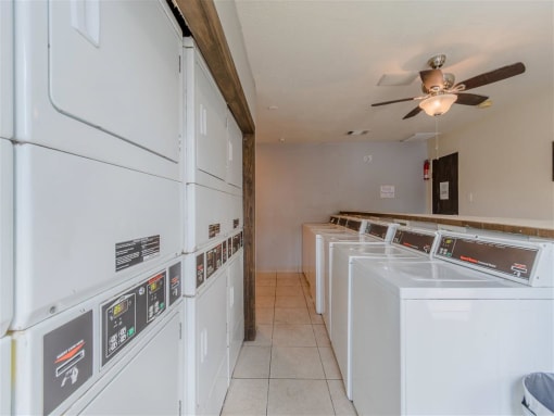 a laundry room filled with washers and dryers at Cityscape, Dallas, TX