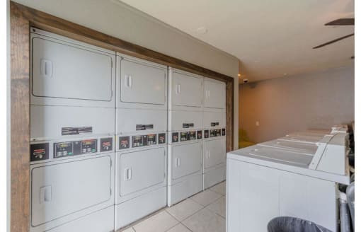 a kitchen with white cabinets and a counter top at Cityscape, Dallas, TX