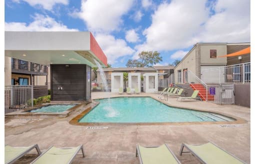 a swimming pool with chairs and a building at Cityscape, Dallas, TX