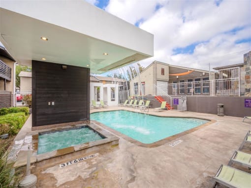 a pool and spa in a backyard with a house at Cityscape, Dallas, TX