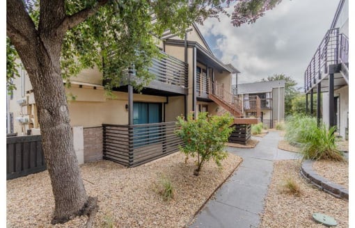 a house with a tree and a sidewalk at Cityscape, Dallas, TX