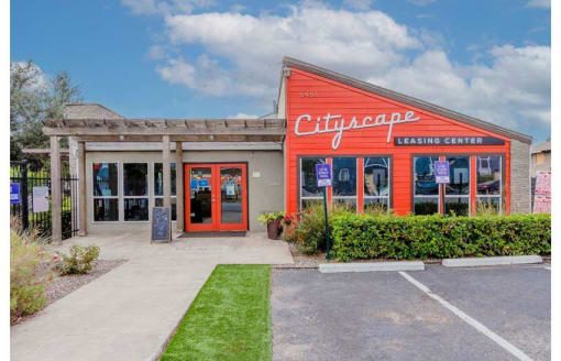 a leasing center with a lawn in front of it at Cityscape, Dallas, TX