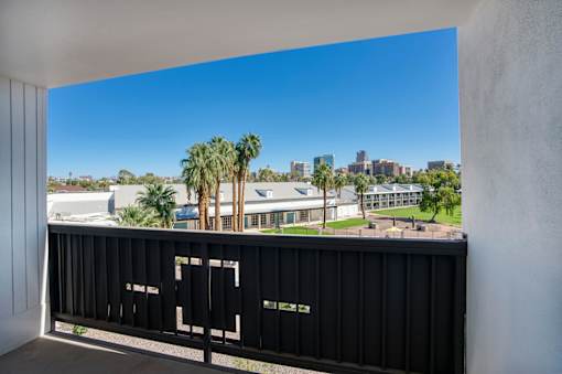 A balcony overlooking the city skyline at Presidio Palms Apartments, Tucson