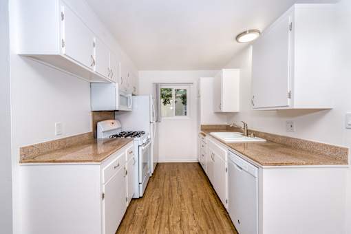 A kitchen with white cabinets
