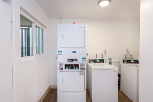 A white washing machine and dryer in a laundry room.