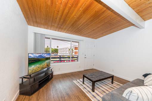 A living room with a television and a couch at The Wave