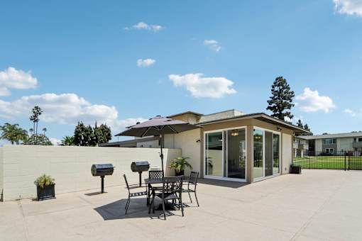 A Grill area with table and chairs