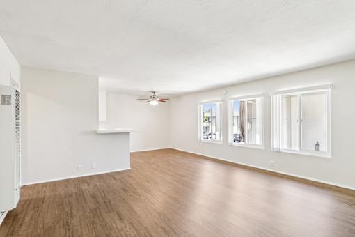 A diningroom with wooden floors and white walls.