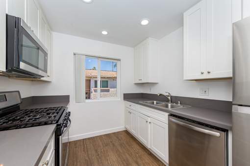 A kitchen with white cabinets