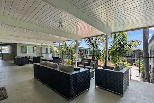 A patio with two couches and a table.