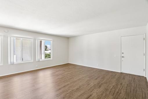 A living room with wooden floors and white walls.