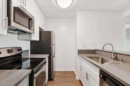 A kitchen with a black refrigerator, stove, and oven.