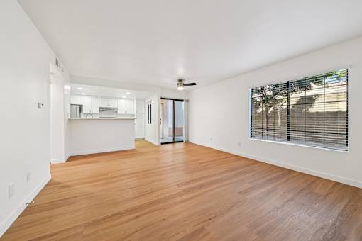 A room with wooden floors and a ceiling fan.
