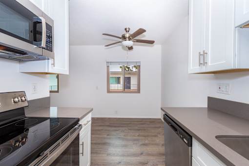 A kitchen with a stove, oven, and microwave.