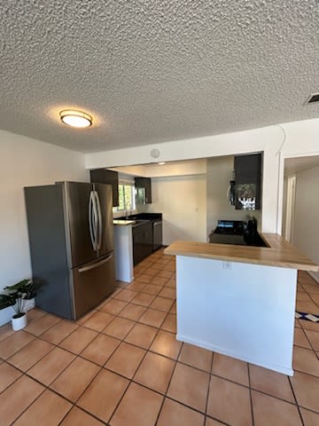 a kitchen with a counter top and a refrigerator