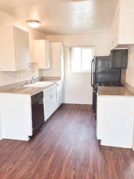 kitchen with white cabinets and black appliances