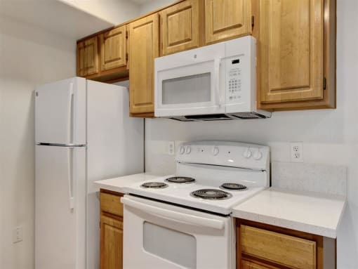 a kitchen with a white stove top oven next to a refrigerator