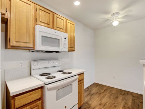 a kitchen with a stove top oven next to a microwave