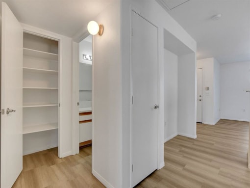 a bedroom with a bed and a bookcase in a room