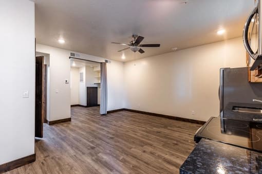 a living room with a ceiling fan and hardwood floors