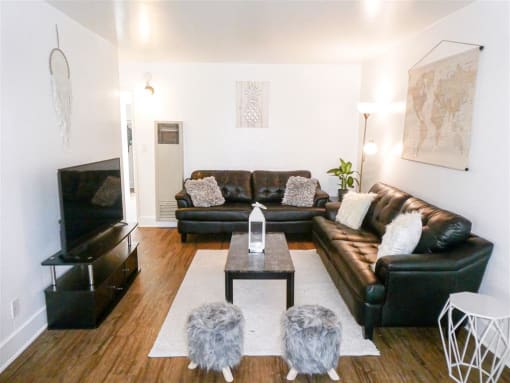 a living room with leather couches and a table
