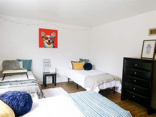 a bedroom with three beds