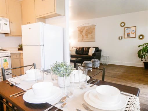 a kitchen and dining room with a table and a refrigerator