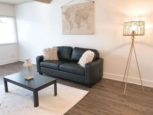 a living room with a black couch and a coffee table