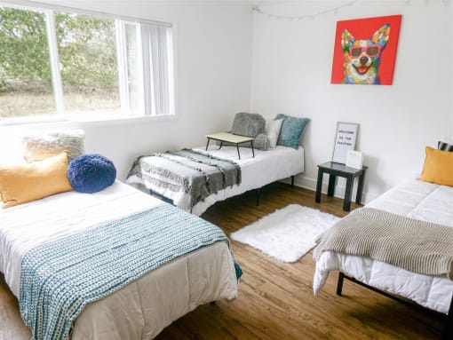 a bedroom with three beds