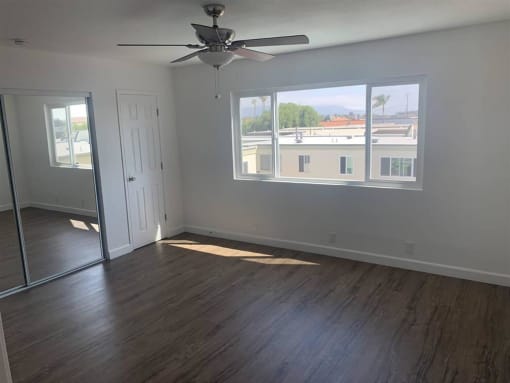 a bedroom with a ceiling fan and a window