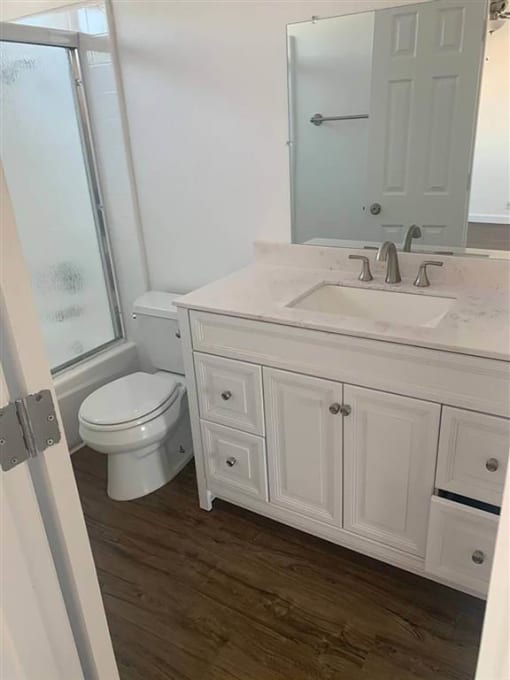 a bathroom with a toilet and a sink and a mirror