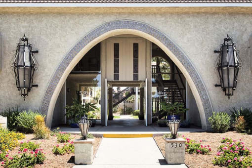 a building with an arched doorway and two lanterns on either side of it