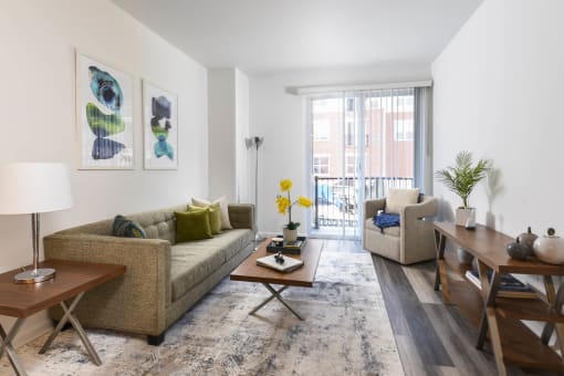 a living room with a couch and a table and a window