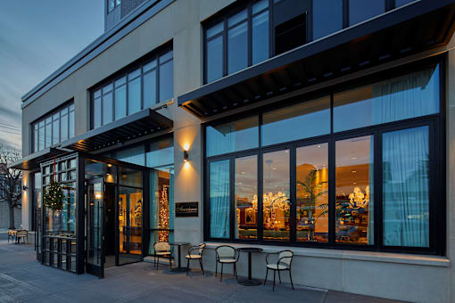 Modern building exterior with retail storefront at Bay One Apartments, Bayonne, NJ