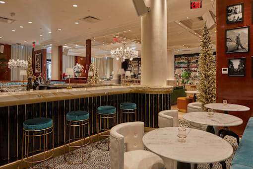 Upscale lounge with marble tables and bar seating at Bay One Apartments, New Jersey