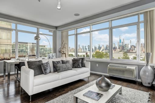 Living room with couch at RiversEdge, Weehawken, 07086