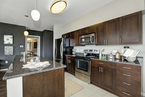 Kitchen with wooden cabinets at RiversEdge, New Jersey, 07086