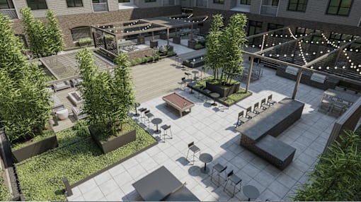 A courtyard with a lot of seating and greenery.