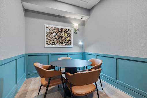 Private dining room with blue wainscoting accents at Aster Grove Apartments, Warren