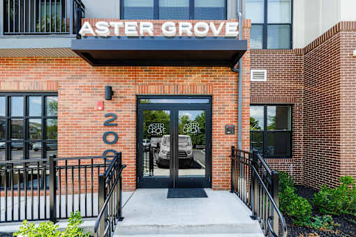 Building entrance with black framed glass doors at Aster Grove Apartments, New Jersey, 07059