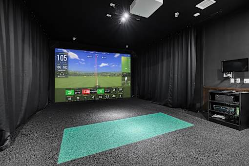 Golf simulation room with hitting mat and screen at Aster Grove Apartments, Warren, New Jersey