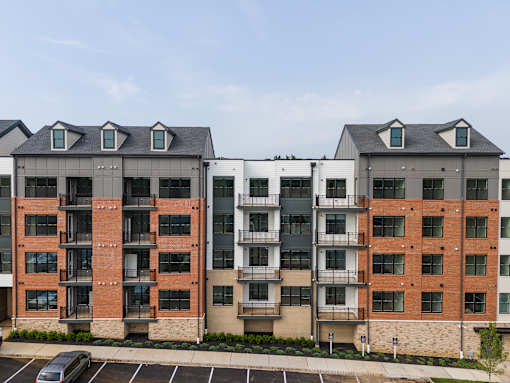 Two apartment buildings with balconies and windows.