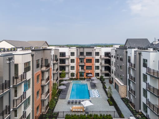 an aerial view of an apartment building with a pool