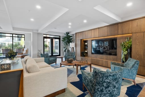 a living room with couches and chairs and a television