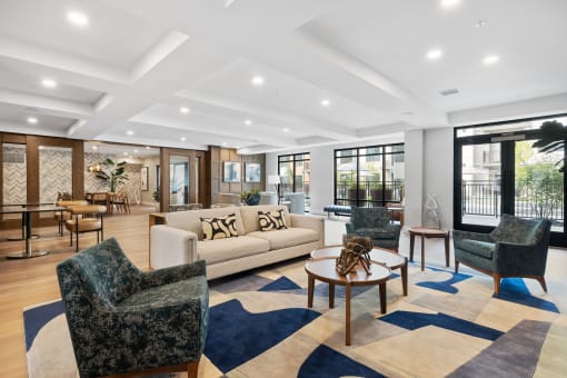 a living room with a couch and chairs and a table